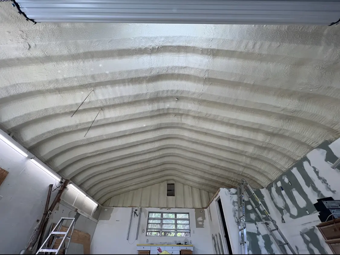 Spray polyurethane foam applied to the underside of a metal roof deck in Crockett